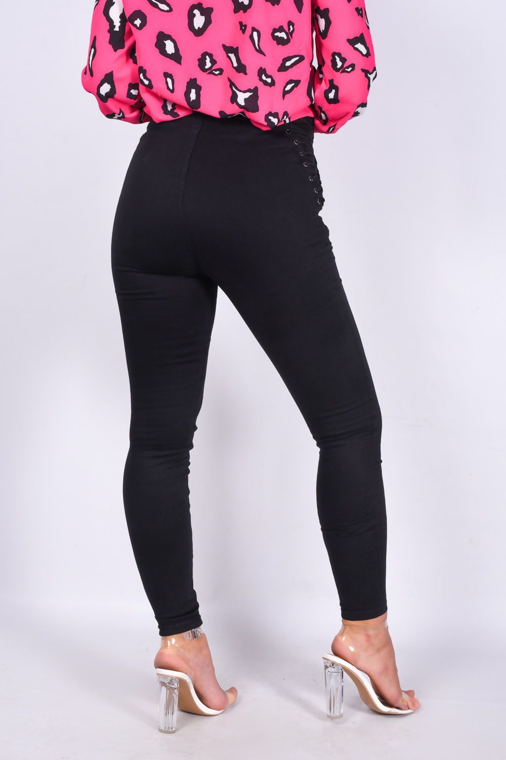 Black denim skinny jeans with lace-up details and a zip front, designed for women by Azure Theseus.