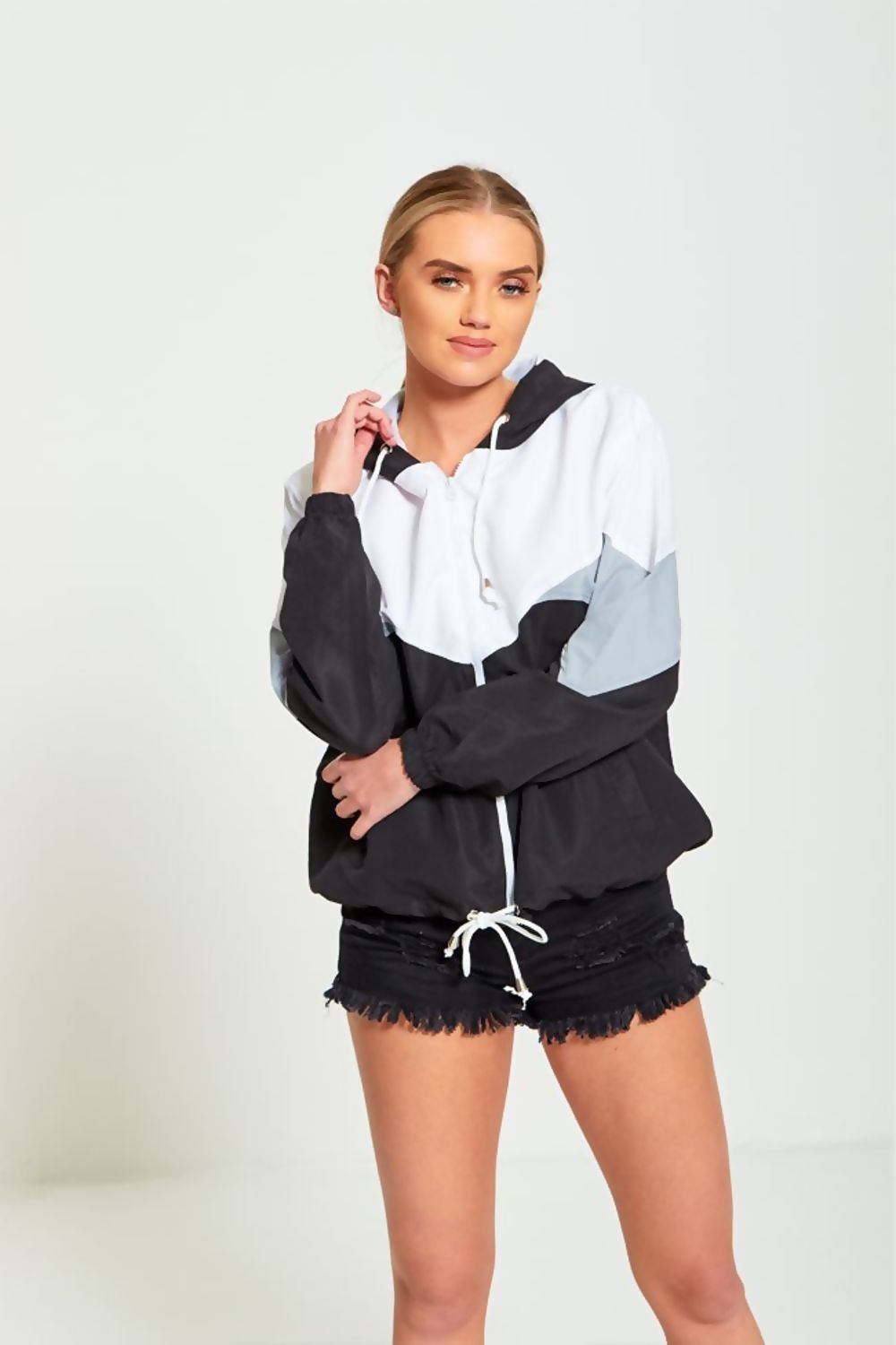 Black two-tone cagoule jacket for women by Azure Theseus, lightweight rain-resistant outerwear with hood and stylish design.