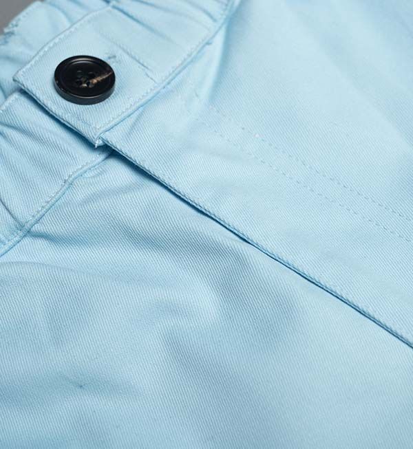 Blue cotton swim shorts by Ruby Tartarus, featuring a comfortable fit and casual style, shown on a flat lay with a white background.