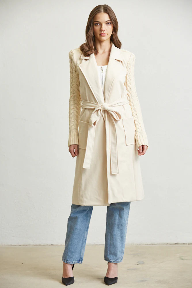 White Amphitryon belted long sweater from Rose Paulino, featuring a cozy knit design and a stylish waist belt for women.