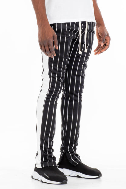 Lime Milo pin stripe track pants with an elastic waistband and tapered fit, featuring classic pinstripe pattern.