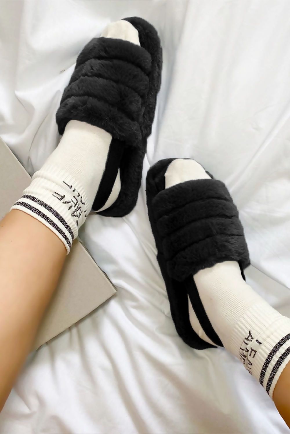 Black faux fur fluffy stripe slippers for women from Azure Theseus, showcasing cozy, plush interior and stylish striped design.