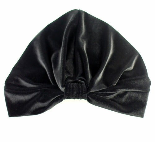 Black stretch velvet turban by Cyan Ismene, a stylish haircare accessory with a smooth, solid velvet fabric.
