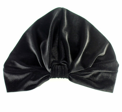 Black stretch velvet turban by Cyan Ismene, a stylish haircare accessory with a smooth, solid velvet fabric.