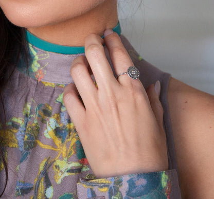 Close-up of Cyan Ismene Bohemian Glam Ring showcasing intricate design and mixed metal details on a plain background.