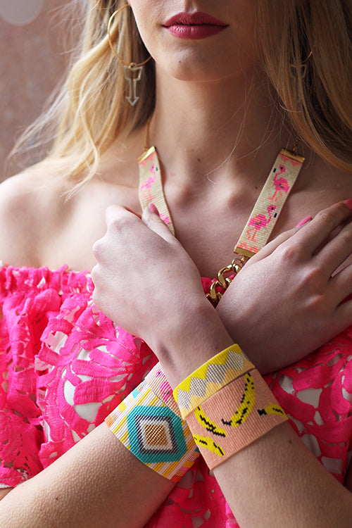 Peach-colored Bananas Bracelet by Yellow Athena featuring a stylish bracelet with banana-shaped charms on a neutral background.