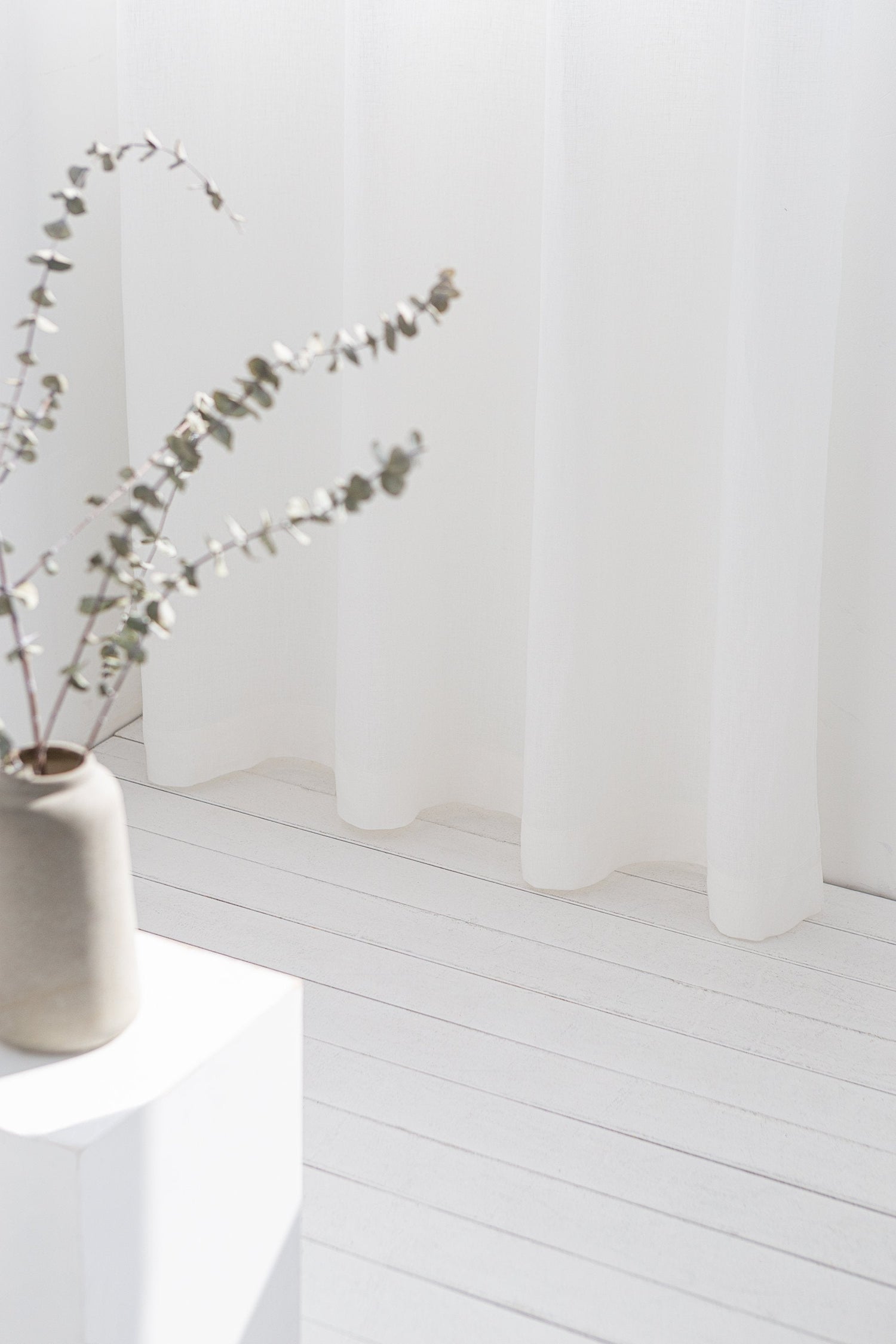 Light grey linen curtain with grommets from Magenta Sugarplum, showcasing a smooth fabric draped with metal grommet top design.