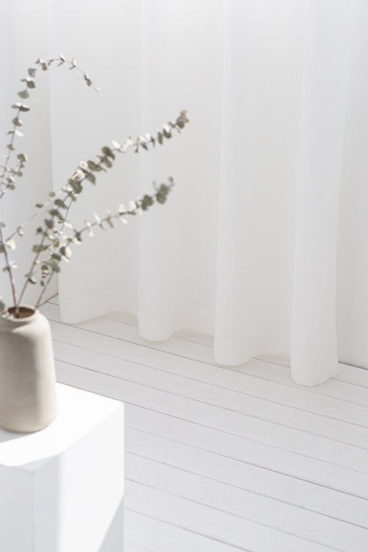 Light grey linen curtain with grommets from Magenta Sugarplum, showcasing a smooth fabric draped with metal grommet top design.