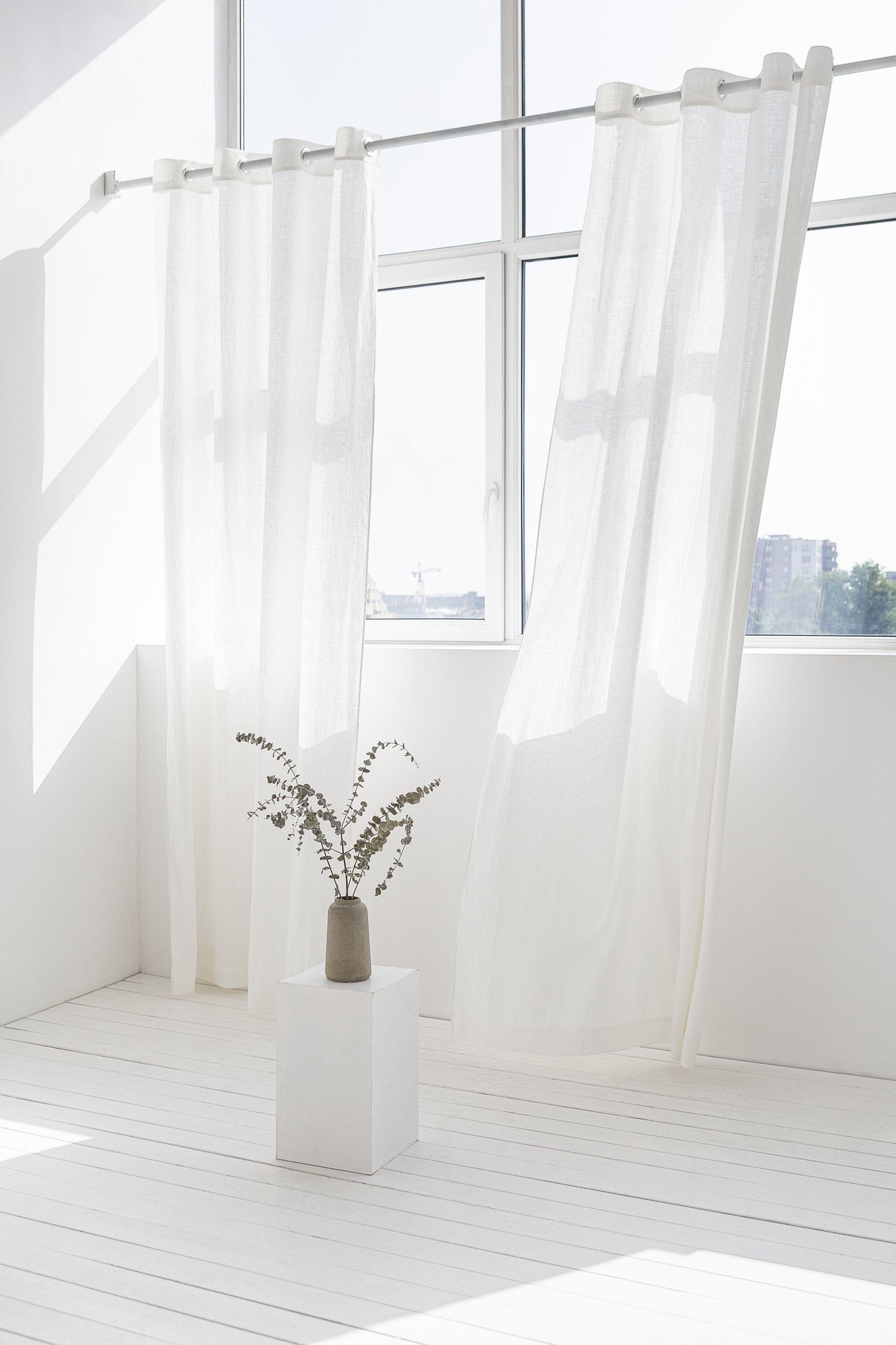 Light grey linen curtain with grommets from Magenta Sugarplum, featuring a soft, textured fabric for elegant home decor.