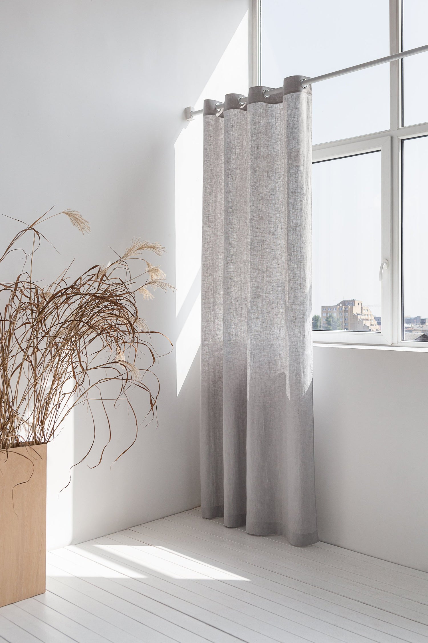 Light grey linen curtain with grommets by Magenta Sugarplum, showing smooth fabric and metal grommet details for home decor.