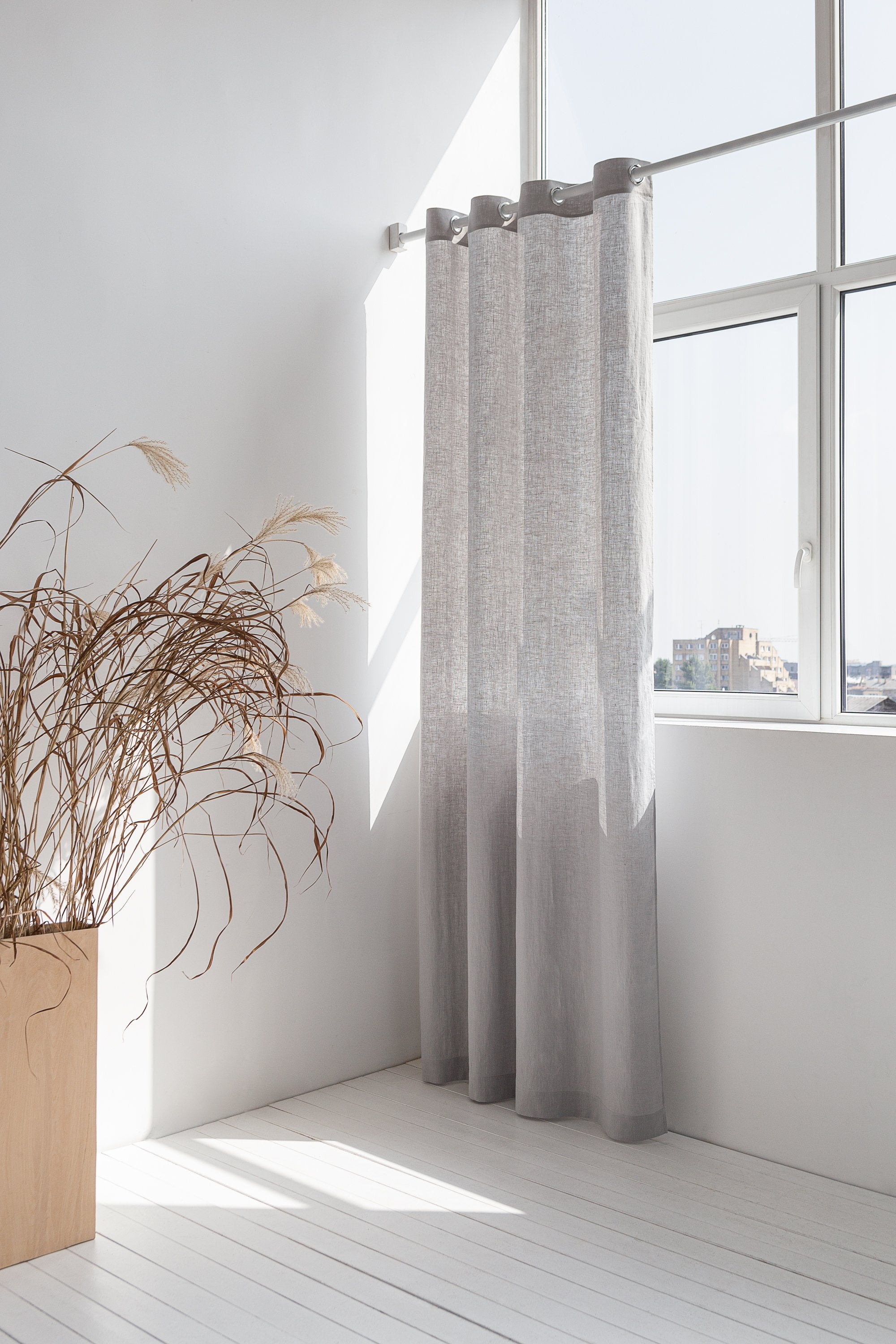 Light grey linen curtain with grommets by Magenta Sugarplum, showing smooth fabric and metal grommet details for home decor.