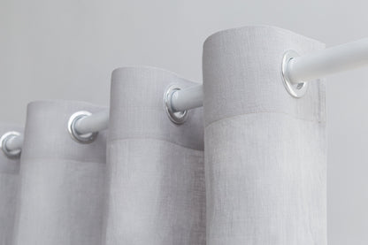 Light grey linen curtain with grommets, Magenta Sugarplum home decor, hanging on a window with natural light.
