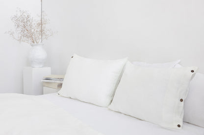 White linen bedding set with coconut button accents, featuring soft fabric and elegant design from Magenta Sugarplum.