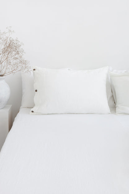 White linen bedding set with coconut button details, stylish home decor from Magenta Sugarplum.