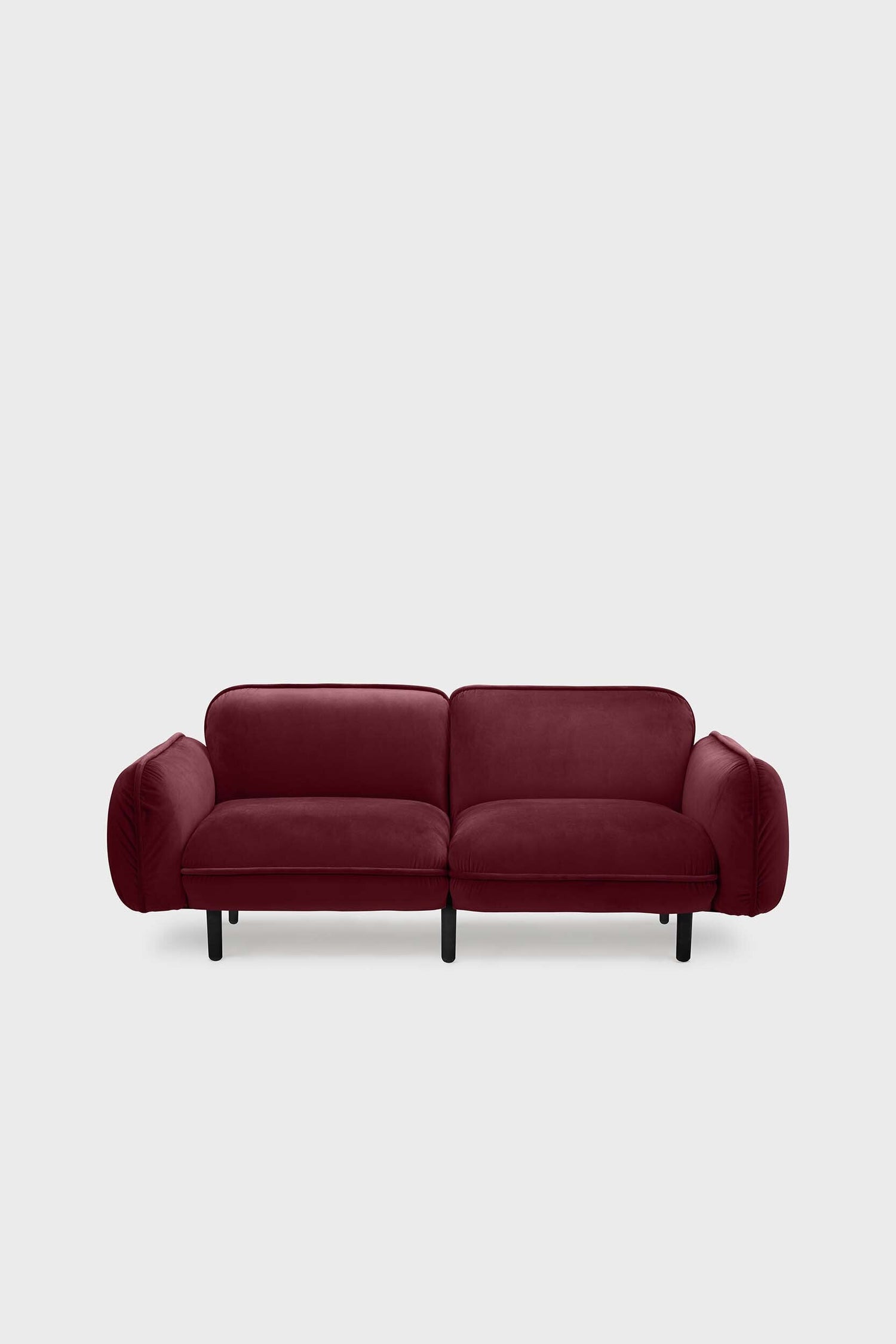 Aquamarine Poppy bean sofa with a deep red upholstery, showcasing plush cushions and modern furniture design.
