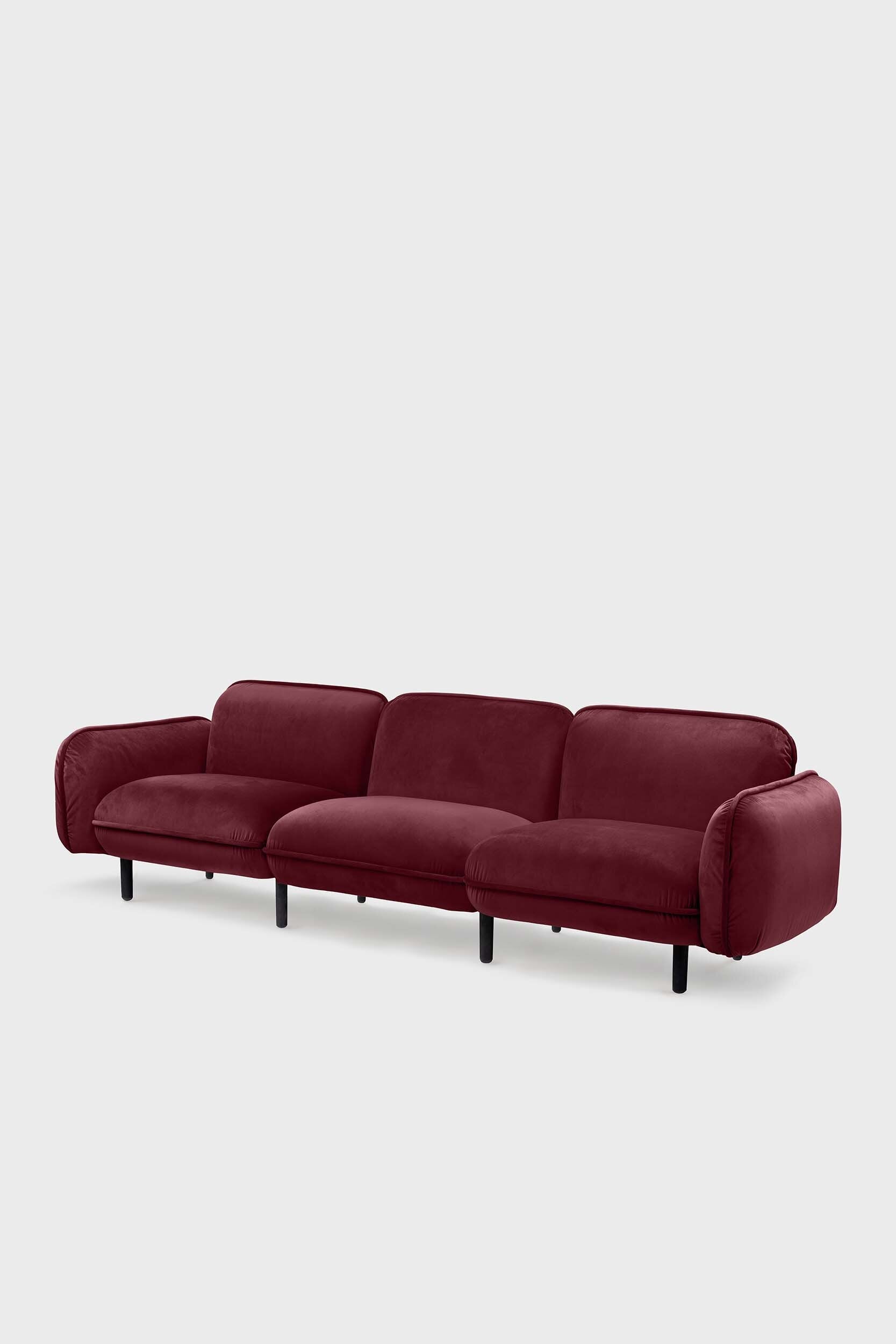 Aquamarine Poppy bean sofa with a burgundy fabric and modern design, featuring plush cushions and a comfortable seating area.