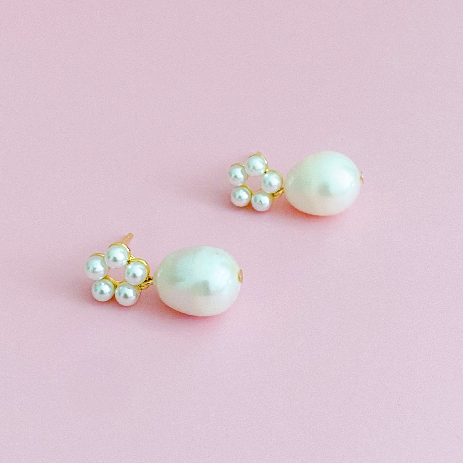 Fuchsia Hercules freshwater pearl drop earrings featuring elegant pearl dangles and silver hooks, showcasing sophisticated jewelry design.