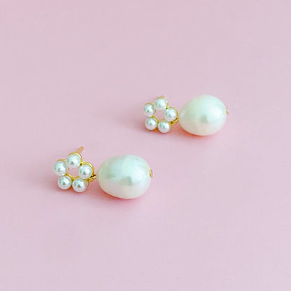 Fuchsia Hercules freshwater pearl drop earrings featuring elegant pearl dangles and silver hooks, showcasing sophisticated jewelry design.