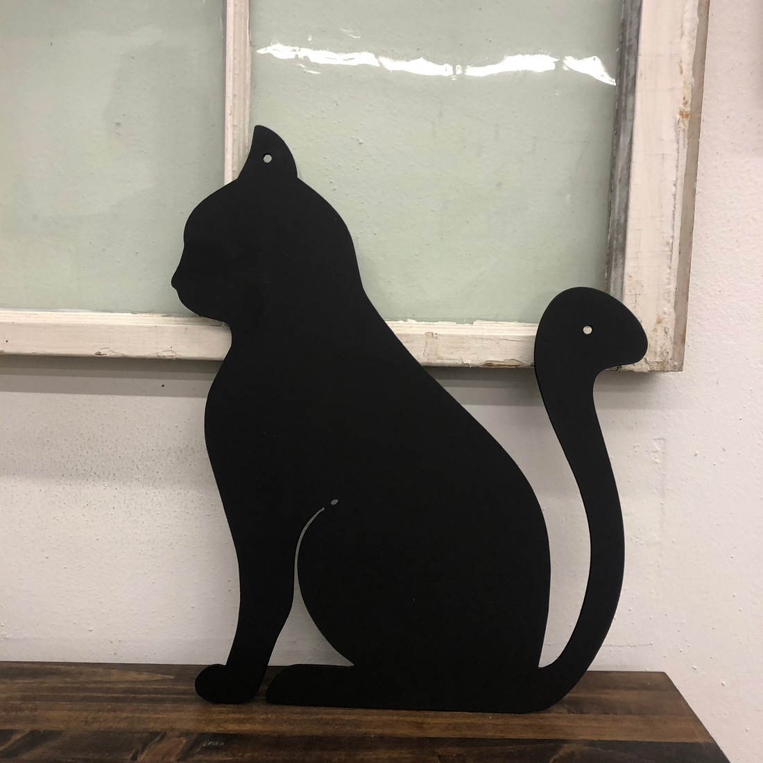Malachite metal wall art featuring a sleek cat design, set against a window background, perfect for home decor.