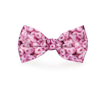 Pink Cheerios dog bow tie from Plum Semele, a cute accessory for pet collars and dog wear, featuring a cheerful cereal pattern.