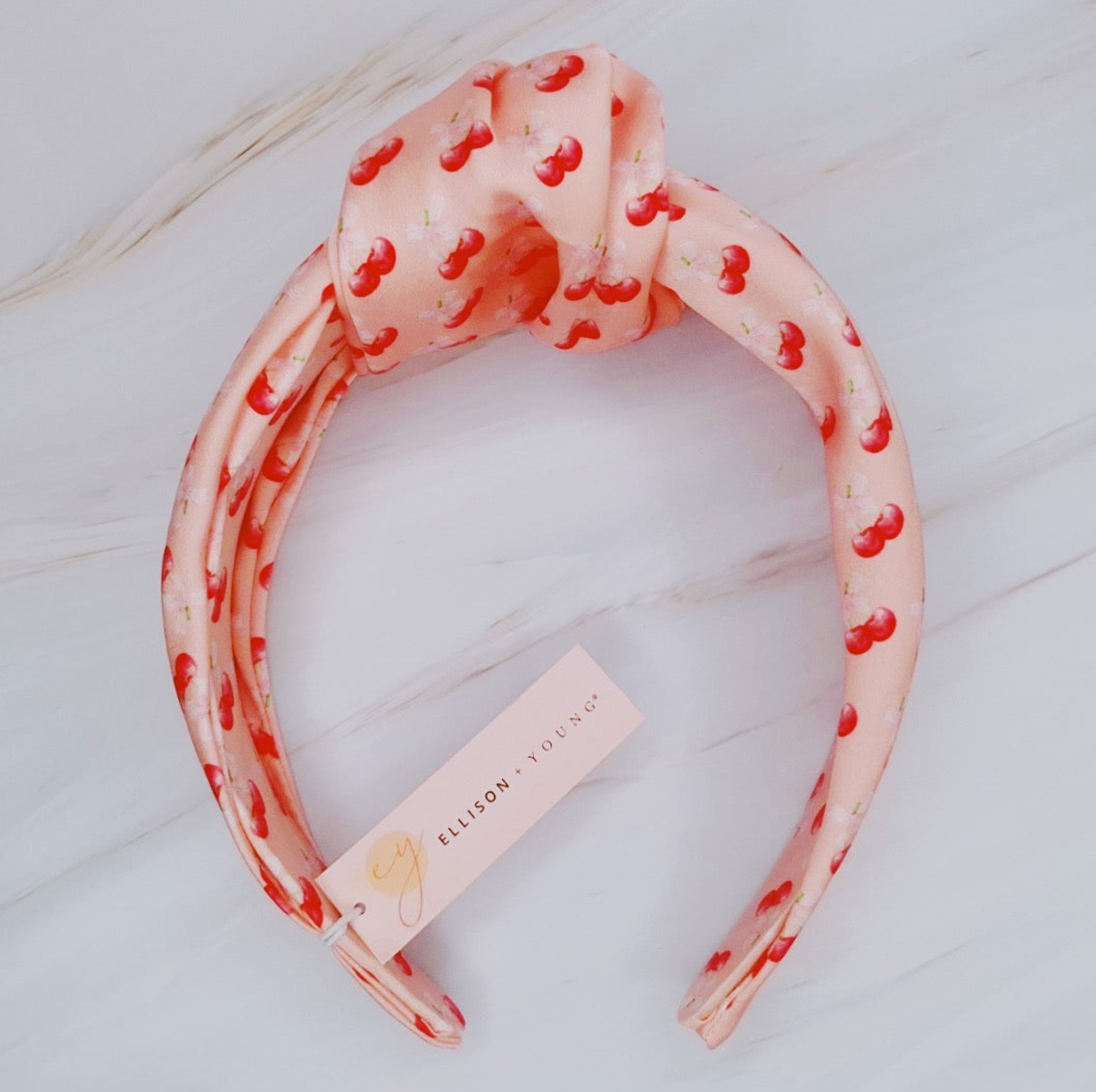 Fuchsia Hercules satin headband with cherry and bow embellishments, stylish jewelry accessory for women.