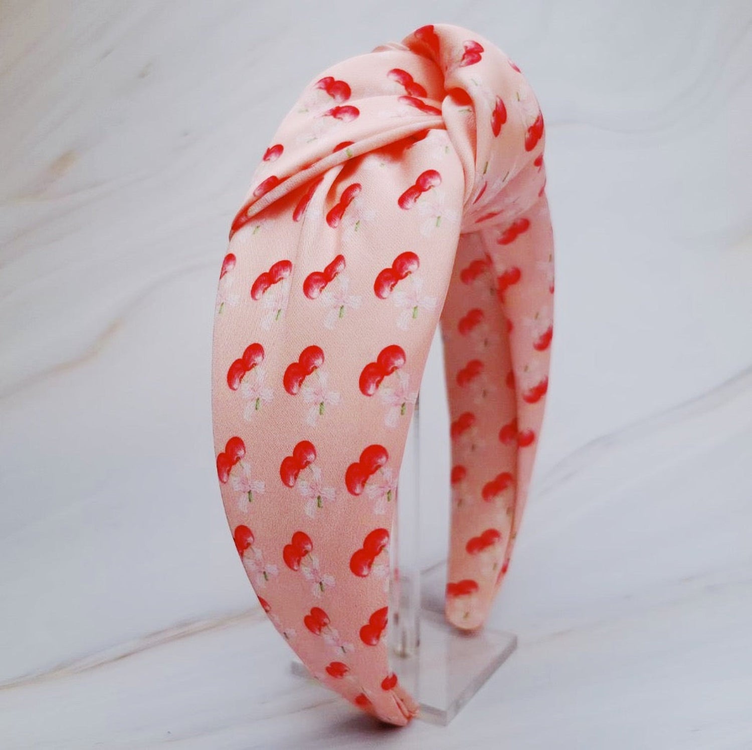Fuchsia Hercules satin headband with cherry and bow design, featuring vibrant red cherries and elegant satin fabric.