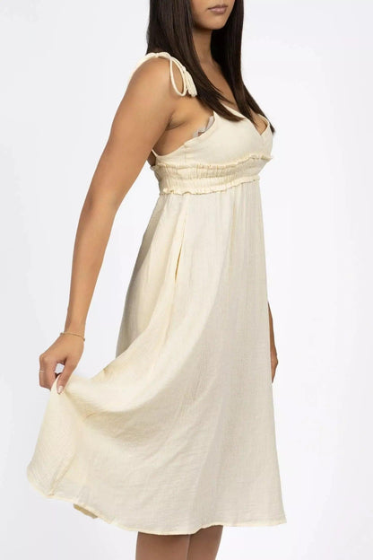 Cream pet dress by Burgundy Perses featuring a V-neck and spaghetti straps, designed for stylish pet fashion.
