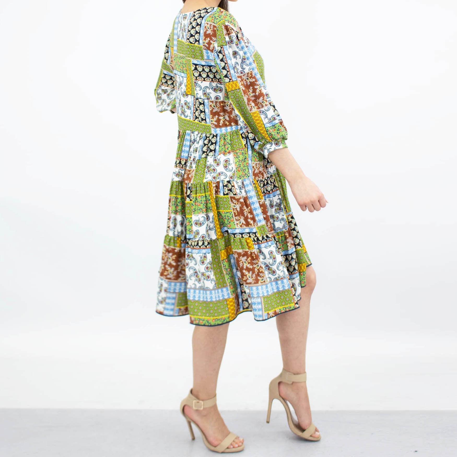 Green flare bottom 3/4 sleeve dress by Yellow Hera, showcasing a stylish and flowy design perfect for casual or semi-formal wear.