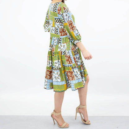 Green flare bottom 3/4 sleeve dress by Yellow Hera, showcasing a stylish and flowy design perfect for casual or semi-formal wear.