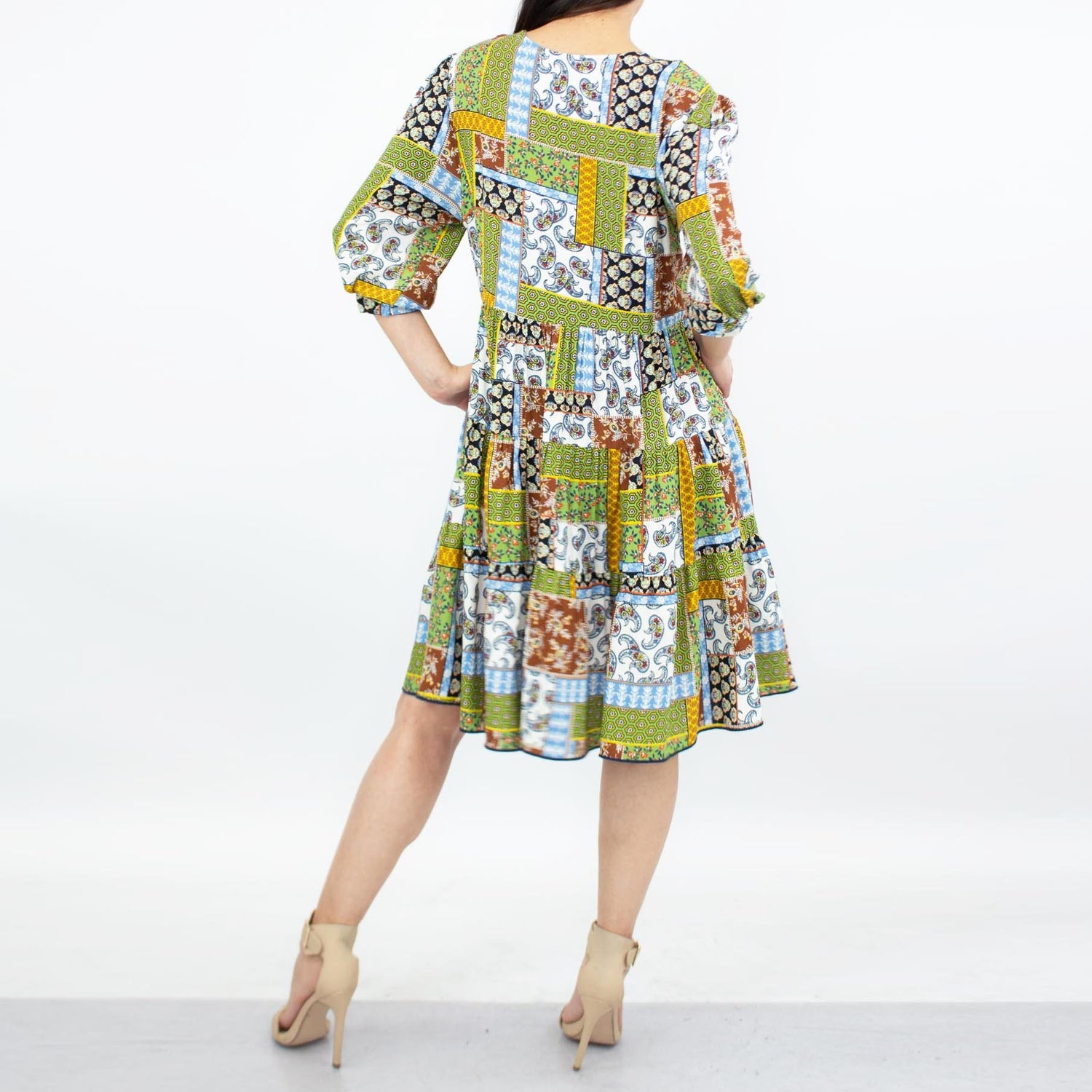 Green flare bottom 3/4 sleeve dress by Yellow Hera, showcasing a stylish and flowy design perfect for casual or semi-formal wear.