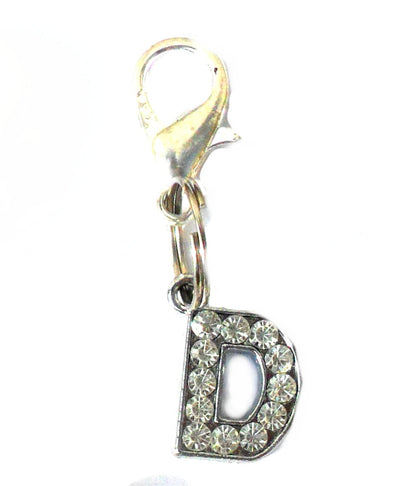 Salmon Oscar A-Z crystal letter pet charm attached to a leash or collar, featuring sparkling crystal accents on a metal letter.