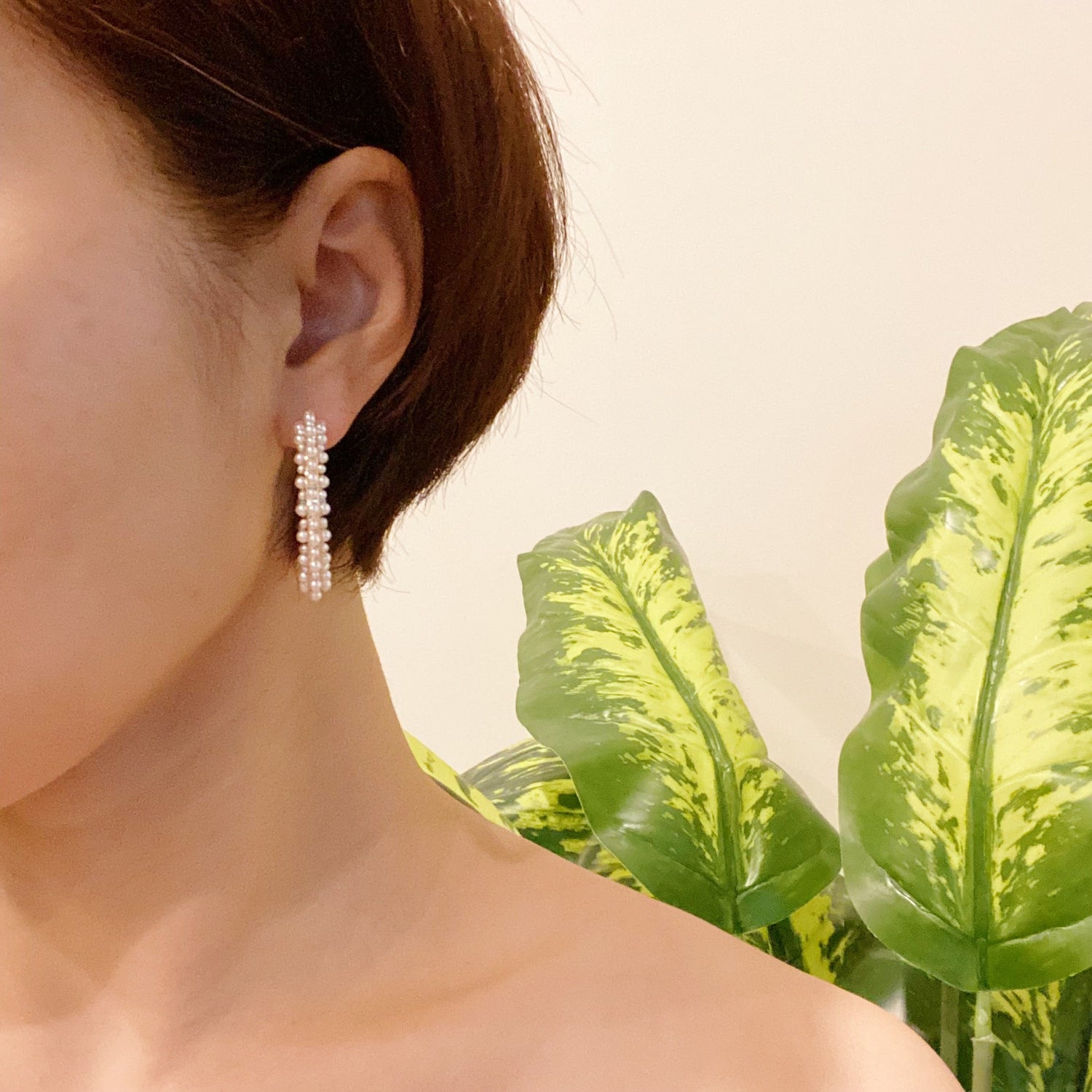 Delicate pearl deco hoop earrings by Fuchsia Hercules, featuring elegant pearl accents on silver hoops for sophisticated style.
