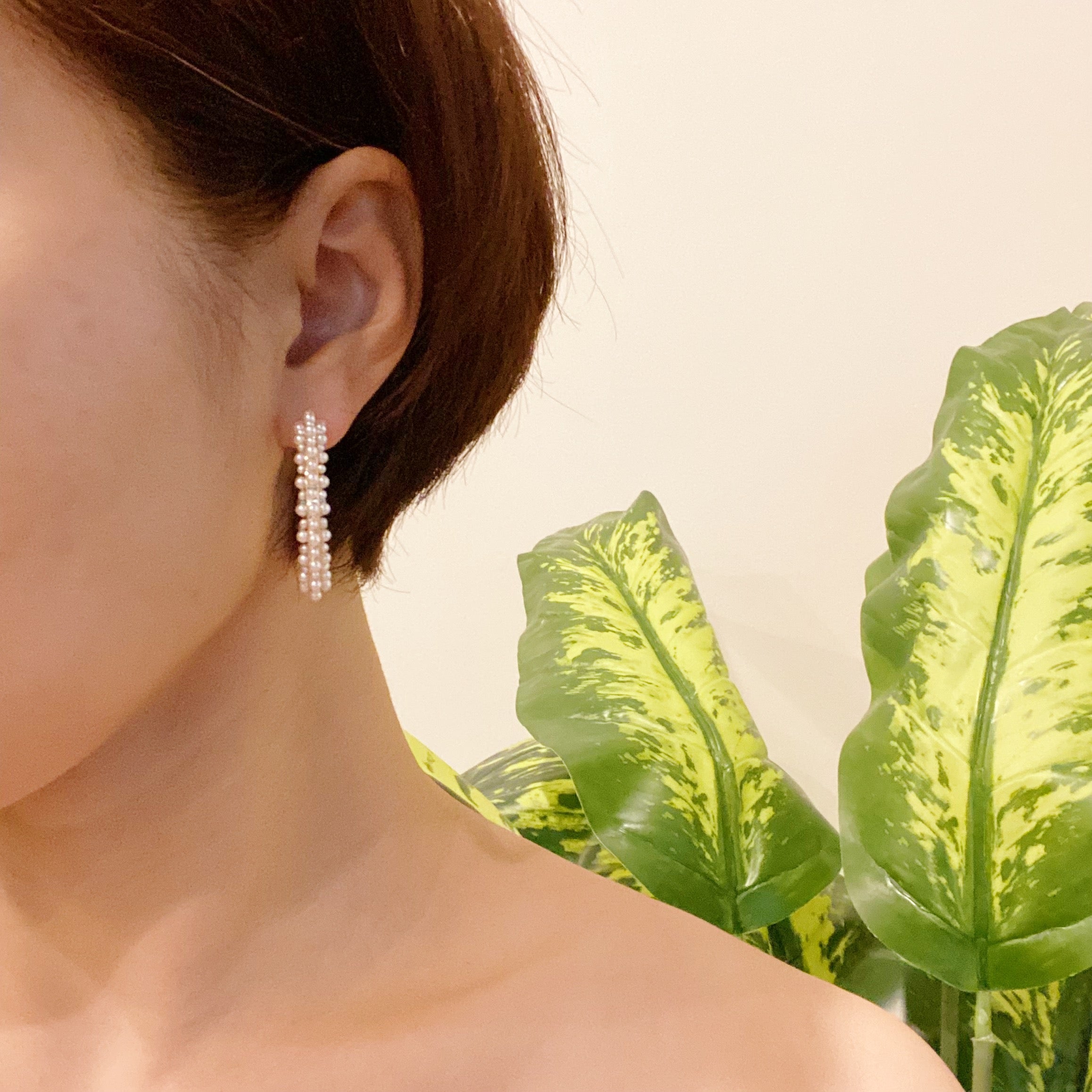 Delicate pearl deco hoop earrings by Fuchsia Hercules, featuring elegant pearl accents on silver hoops for sophisticated style.