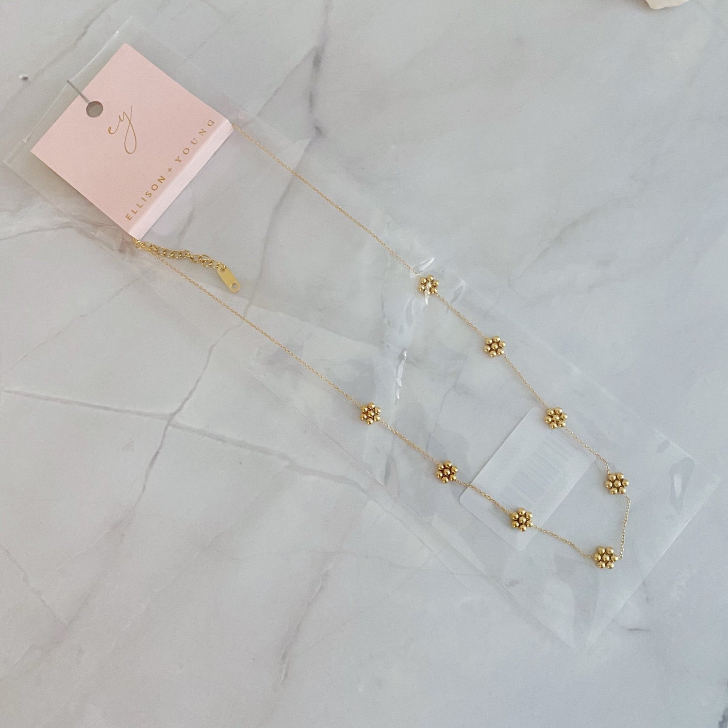 Dainty golden bead flower necklace made of waterproof stainless steel, stylish jewelry piece by Fuchsia Hercules.