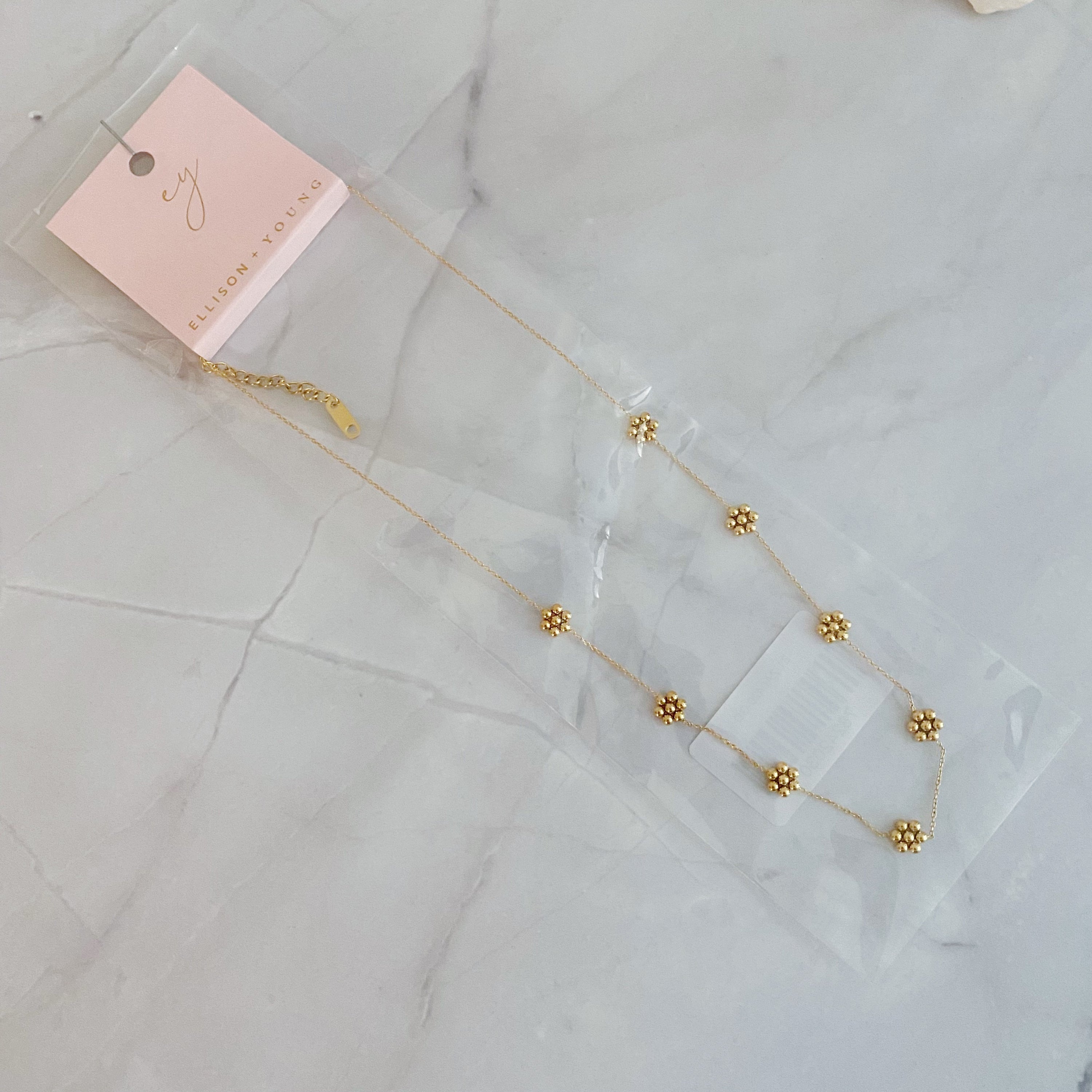 Dainty golden bead flower necklace made of waterproof stainless steel, stylish jewelry piece by Fuchsia Hercules.