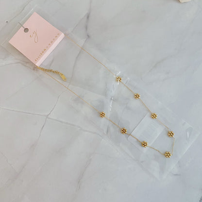 Dainty golden bead flower necklace made of waterproof stainless steel, stylish jewelry piece by Fuchsia Hercules.