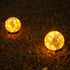 Pink Iolaus outdoor solar crack bottle 20-light waterproof decorative lighting displayed outdoors in a garden setting.
