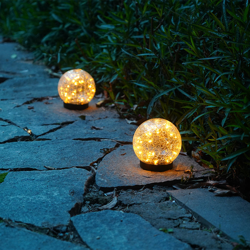 Pink Iolaus outdoor solar crack bottle 20-light waterproof decorative lighting setup in a garden or outdoor space.