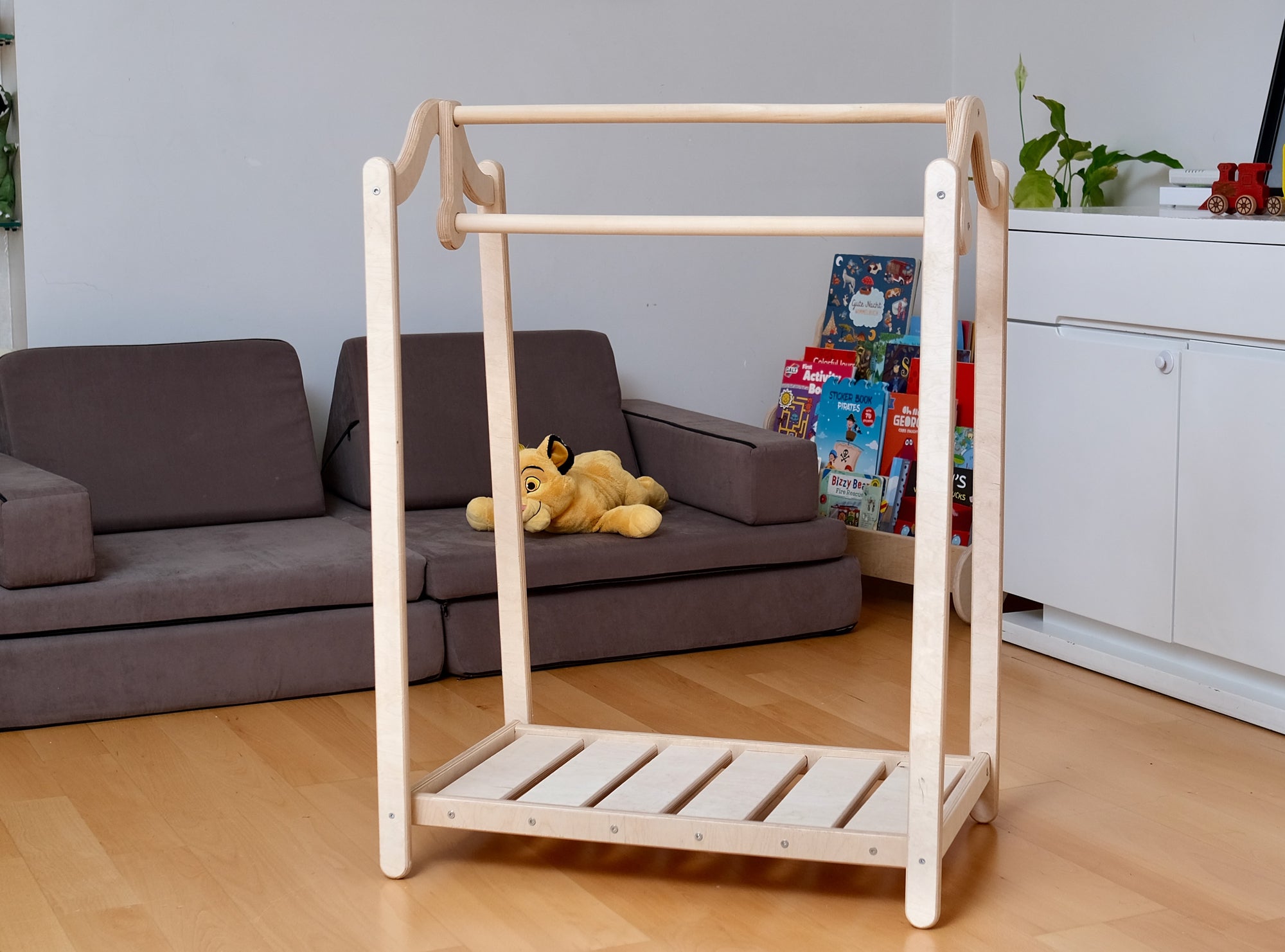 Wooden kids clothing rack from Red Oceanus featuring a sturdy design and natural wood finish, ideal for children&