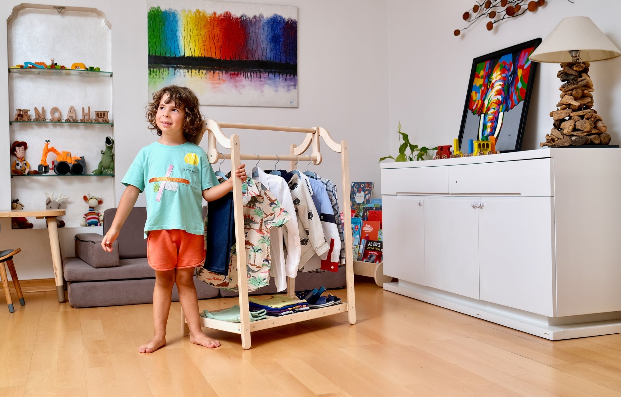 Wooden kids clothing rack from Red Oceanus featuring a simple, sturdy design with hooks and storage for children&
