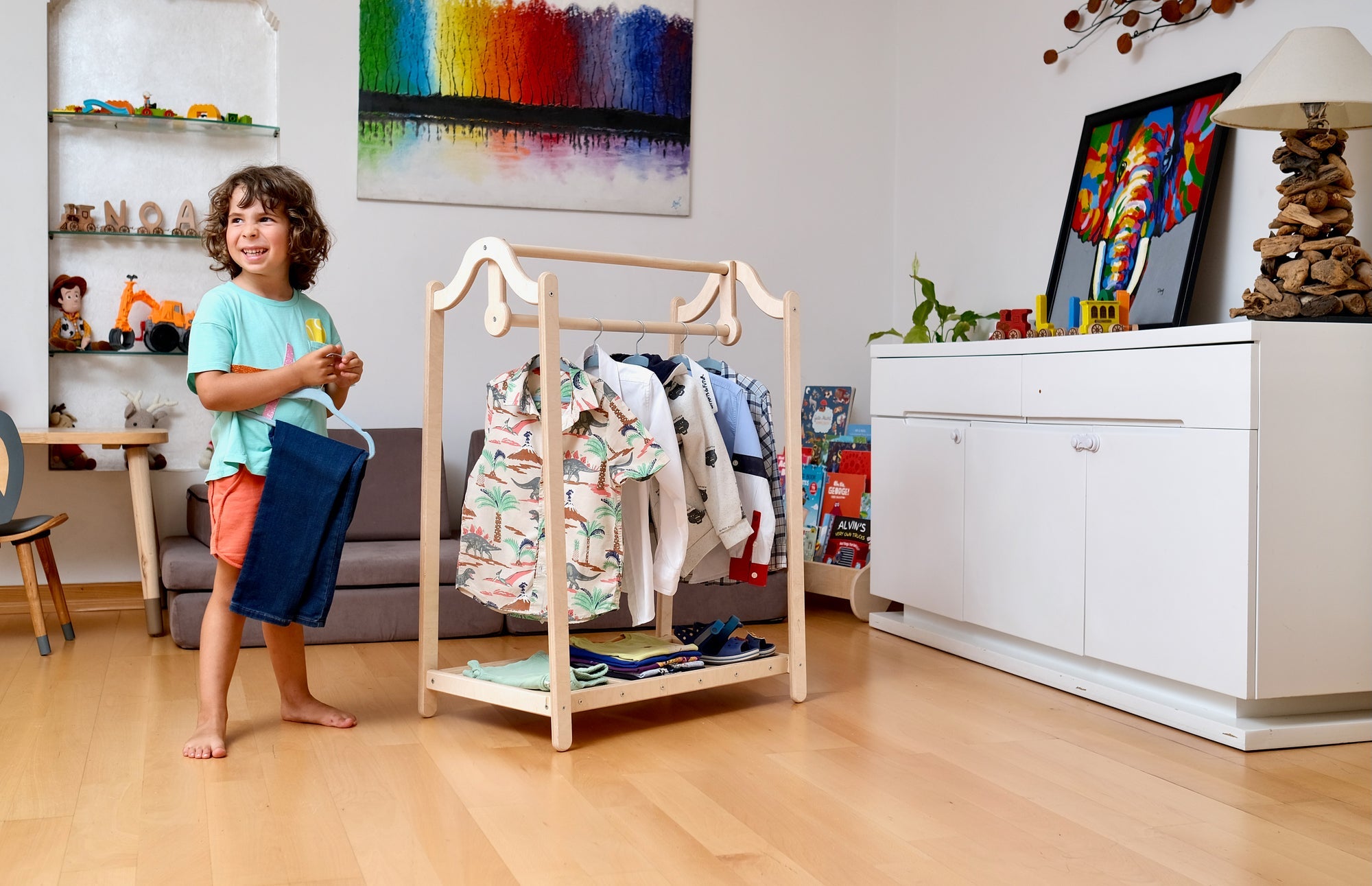 Wooden kids clothing rack by Red Oceanus, showing a sturdy furniture piece with hooks and a lower shelf for children&