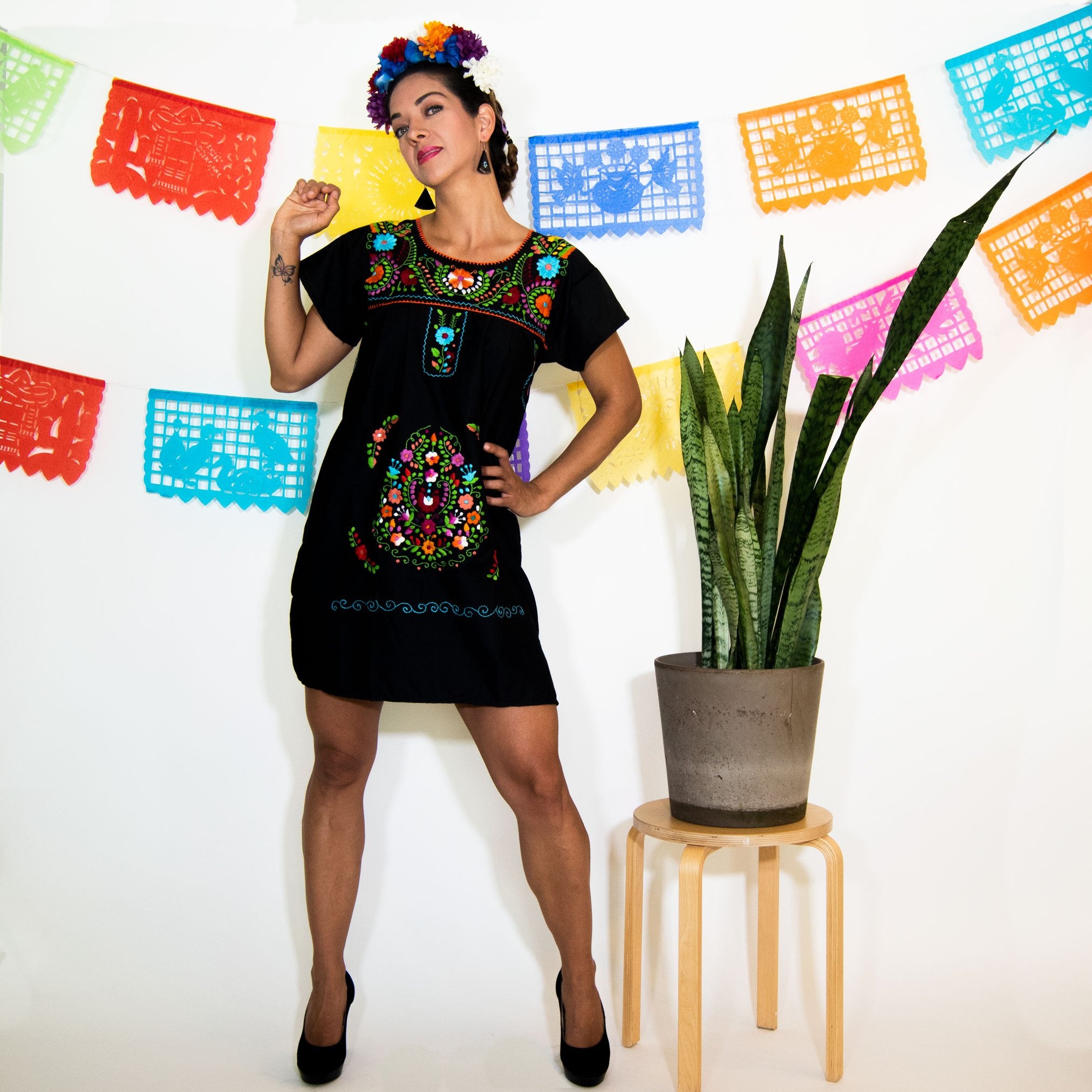 Violet Athena black Mexican dress for women with multicolored floral patterns and flowing fabric.