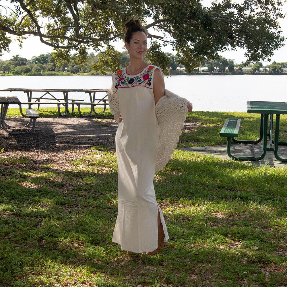 White Maxi Isidra dress by Violet Athena featuring intricate Mexican embroidery, flowing fabric, and elegant bohemian style.