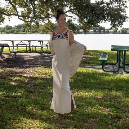 White Maxi Isidra dress by Violet Athena featuring intricate Mexican embroidery, flowing fabric, and elegant bohemian style.