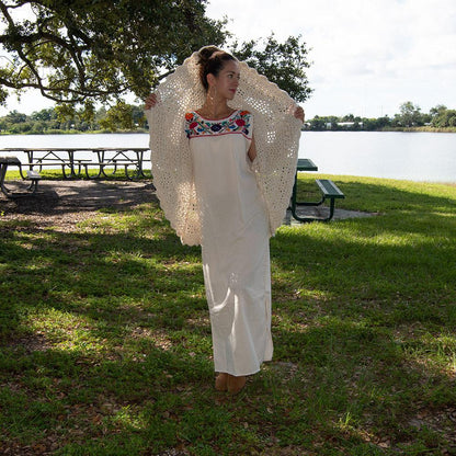 White Maxi Isidra Mexican embroidered dress for women by Violet Athena, featuring intricate embroidery and flowing fabric.