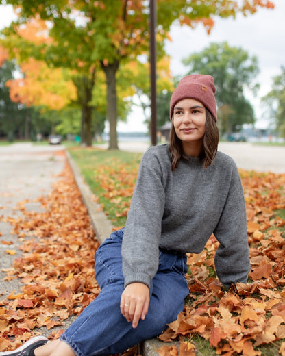 Azure Arrowwood HAAKWEAR knit cuffed beanie in rusty burgundy, showcasing soft knit fabric and cozy cuffed design.