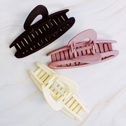Set of three Fuchsia Hercules hair claw clips, stylish jewelry accessories for holding hair in place, shown in the image.