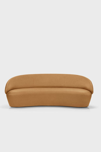 Aquamarine Poppy Naïve Sofa in light fabric with plush cushions and wooden legs, placed in a modern living room setting.