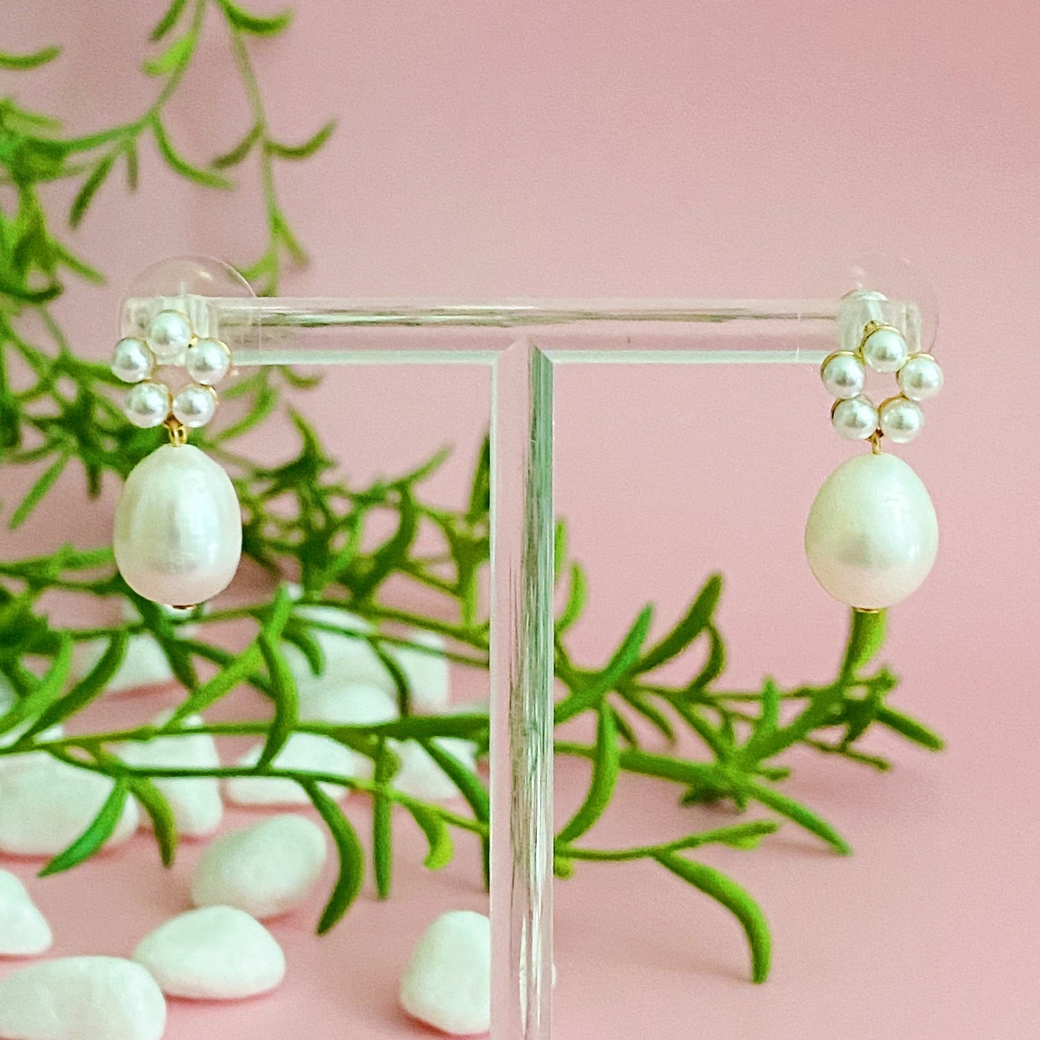 Fuchsia Hercules freshwater pearl drop earrings with elegant gold hooks, showcasing shiny, round pearls on a white background.