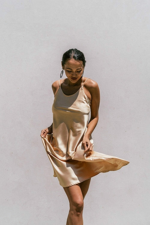 Light gold satin slip dress for women by Azure Thanatos, featuring a minimal Florida-inspired design and elegant fit.